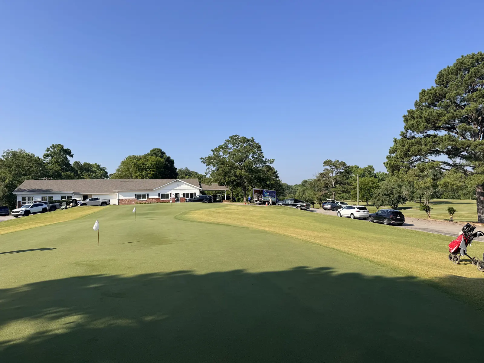 Clubhouse and practice green at Creeks Bend